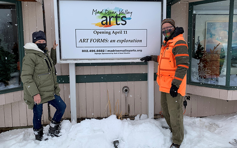 Mad River Valley Arts executive director Kira Bacon and director of exhibitions Gary Eckhart put the finishing touches on the new sign at the gallery in the Village Square Shopping Center. Photo: June Anderson.