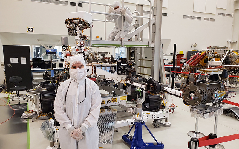 Emmy Kelly stands in front of the Perseverance rover at the NASA jet Propulsion Laboratory (JPL) in California. Photo courtesy Emma Kelly.