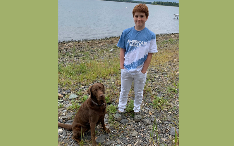 Aiden Heath, pictured with his dog Angel, has type 1 diabetes and wants to be vaccinated but because he is under 16 he is not eligible. 