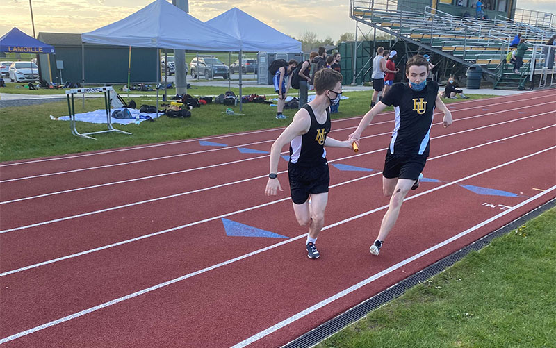 Jack Meyers hands off to Ty Silveira in the 4x400m relay on May 13 at BFA St. Albans.