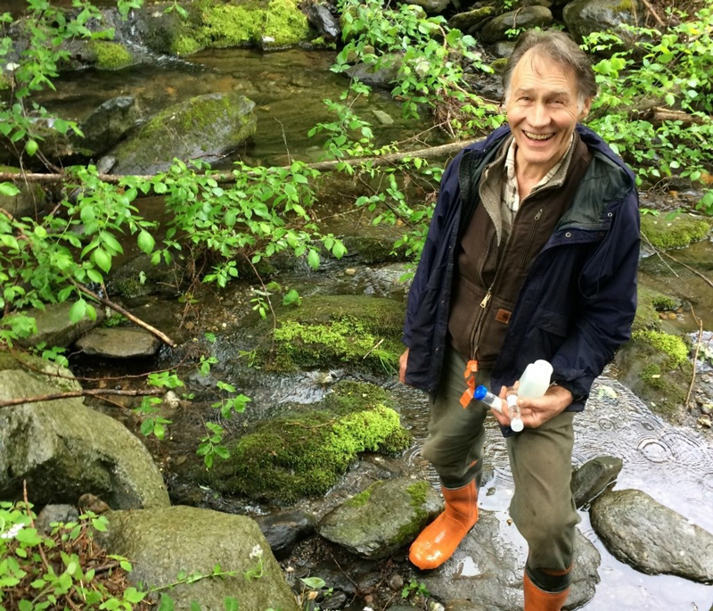 A Mad River Watch volunteer captures water samples from a headwater tributary. Photo: Kinny Perot