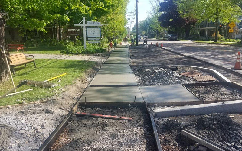 The first sections of concrete have been poured in front of the Valley Players Theater and the former Methodist Church. Photo: Pat Travers.