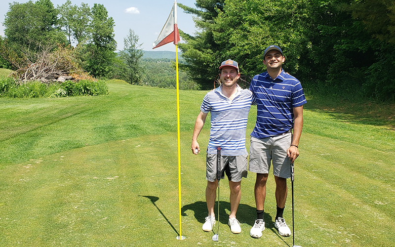 Adam Barlow, left, and Pranav Mohan on Green no. 6 behind the famous burn pile hazard at Woodchuck Golf