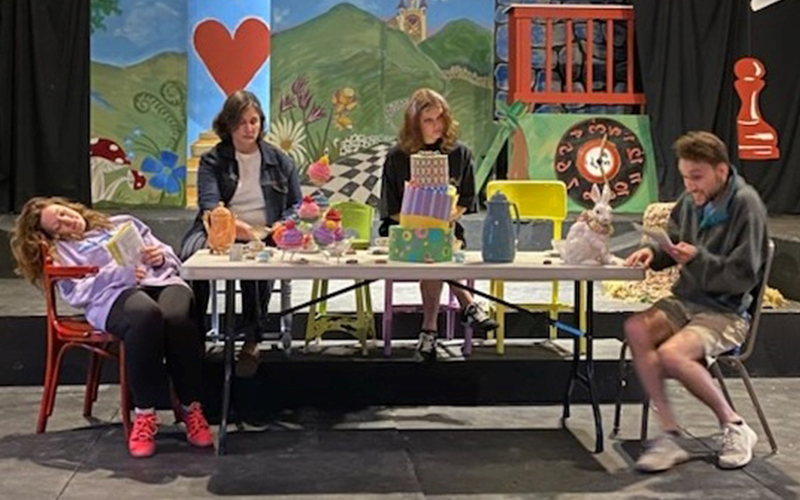 From L to R: Cassandra Demaris, Mikki Nucci, Zoe Blackman, Josh Huffman rehearsing a scene from the Mad Hatter's tea party in “Alice's Adventures in Wonderland,” opening July 9.