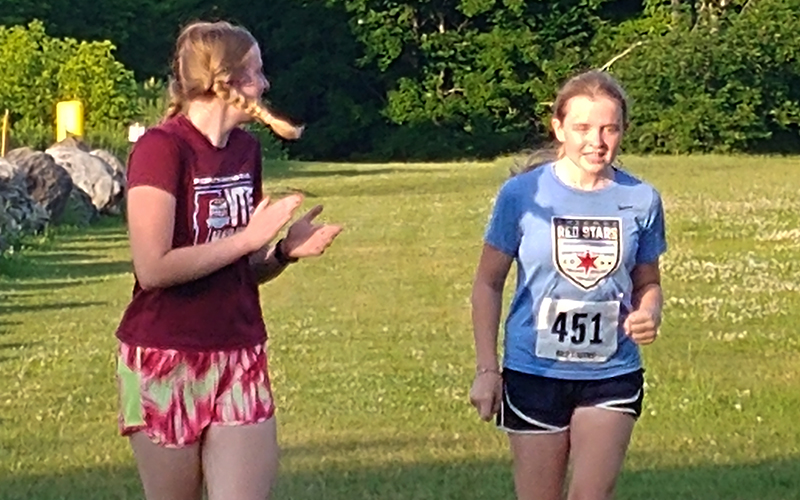 The McDonough sisters, Caelyn and Eireann, cheer each other on at the June 28 Harwood Fun Run. Eireann McDonough took first place in the 12 and under category while Caelyn placed first in the 5km. Photo: Ann Zetterstrom.