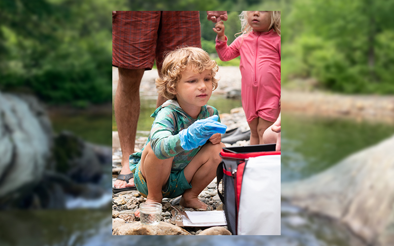 A young volunteer tests for phosphate at Riverside Park. Credit: Friends of the Mad River