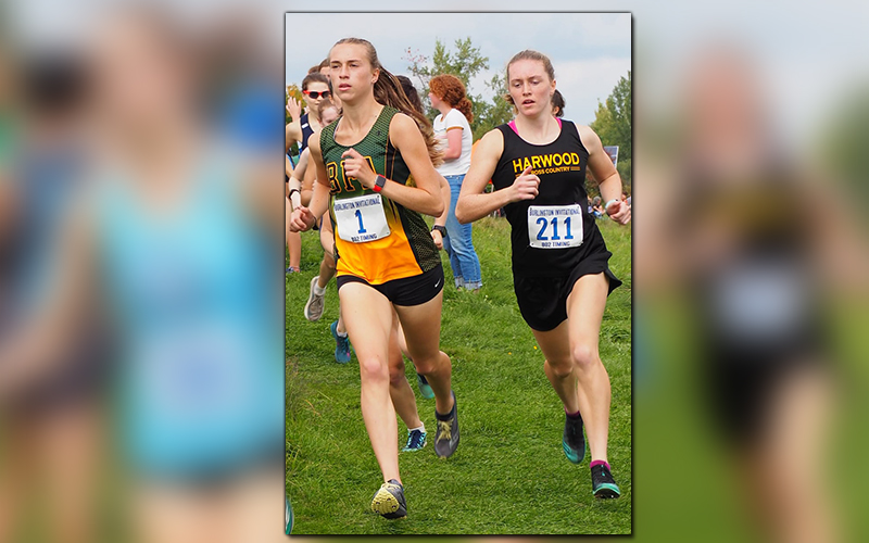 Ava Thurston #211 battles #1 Logan Hughes at the Burlington XC Invitational. Photo: Ann Zetterstrom.