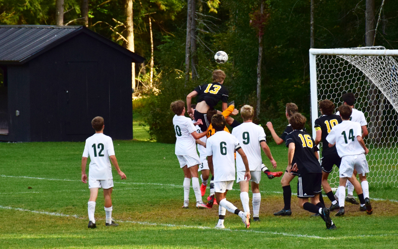 Harwood's Zach Smith jumps for a header in the second half of Harwood's 2-1 win over Montpelier on Tuesday. Photo: Jeff Knight