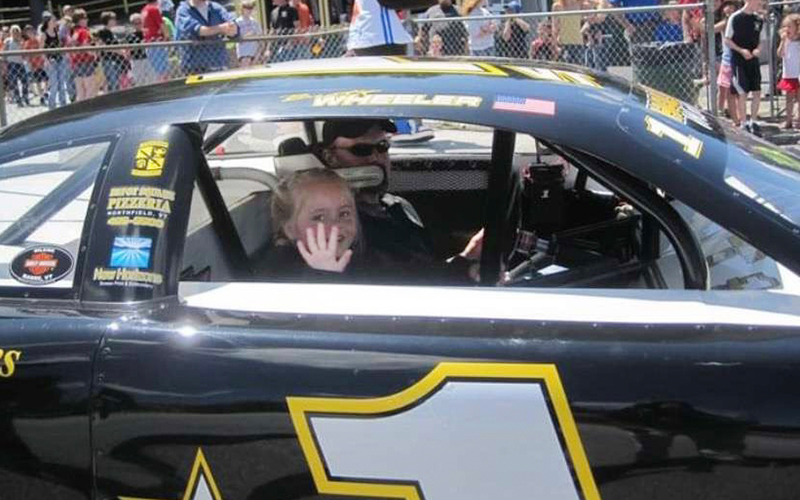 A young Shea Wheeler rides with her father at Thunder Road.