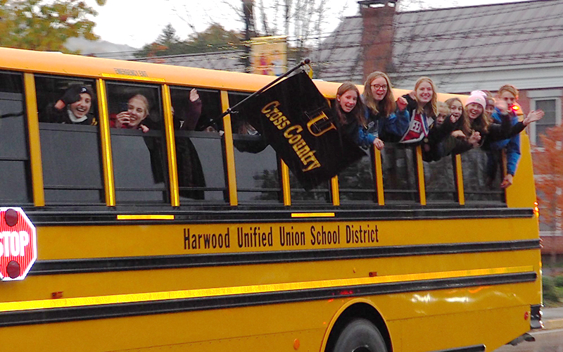 Harwood girls' cross country team received a fire truck escort through Waterbury after their D2 state championship win. Photo: Ann Zetterstrom