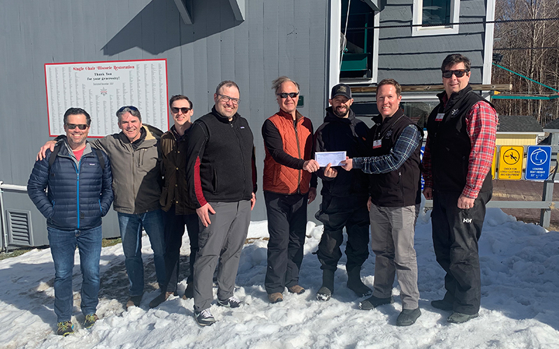 Mad River Glen co-op members and officials present a check to Win Smith and Chad Borofsky for Three Peaks Medical Clinic. From left: Brad Noble, Andrew Carey, Will Kriewald, Matthew Milan, Win Smith, Chad Borofsky, Andrew Snow and Matt Lillard. Photo courtesy of MRG.