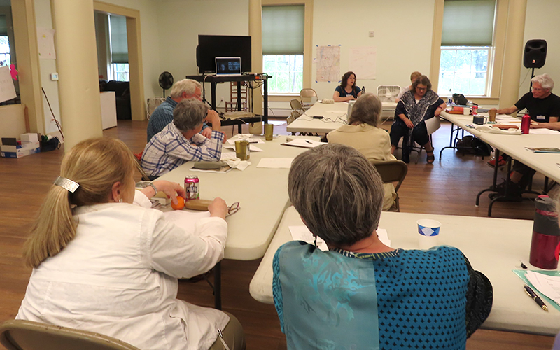 Vermont poets sitting around tables.