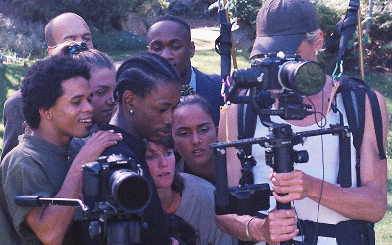 Brin Schoellkopf filming with students of MOYA looking on.