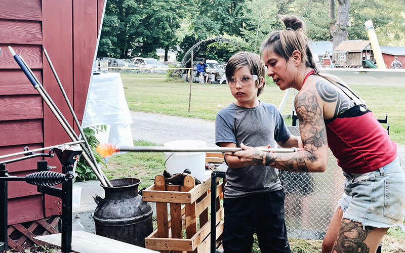 Glassblower Samantha Lightner demonstrating her craft.