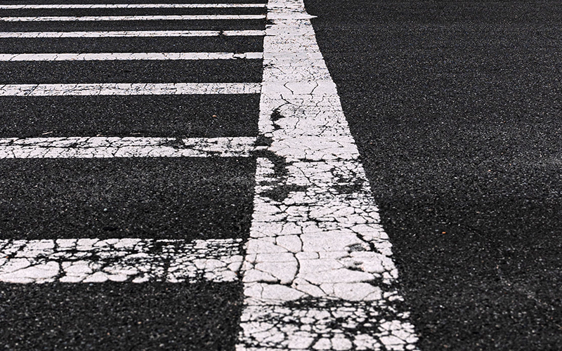 a crosswalk across a well traveled road.