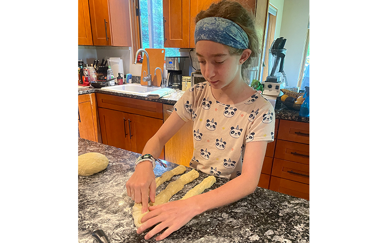 Waitsfield Elementary School student Mirah Lutsky making challa bread to raise money for Everybody Wins!