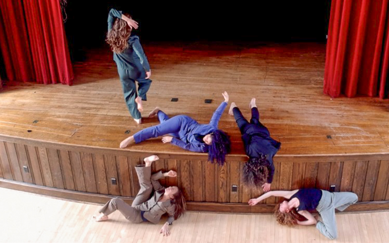 Lunch dance company dancers strewn across  the stage.