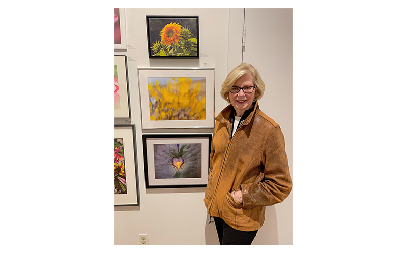 Joan Robbio with some of her photography.