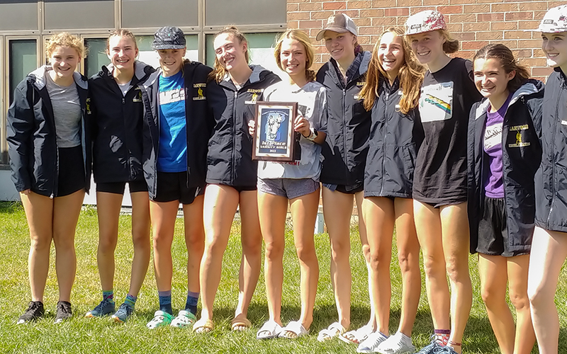 The Harwood girls’ cross-country team took first place at the U-32 Invitational held Saturday, September 17. Left to right: Hadley Andersen, Rowan Clough, Heidi Halversen, Libby Spina, Charlie Flint (holding plaque), Maisie Franke, Celia Wing, Julia Thurston, Pippa Diller, and Hazel Lillis. Photo: John Kerrigan.