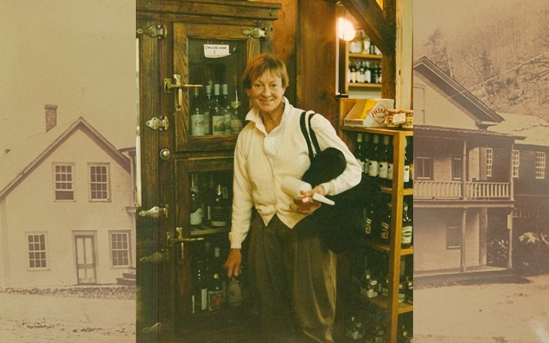 Carol Lippencott standing in front of one of The Warren Store's vintage refrigerators.