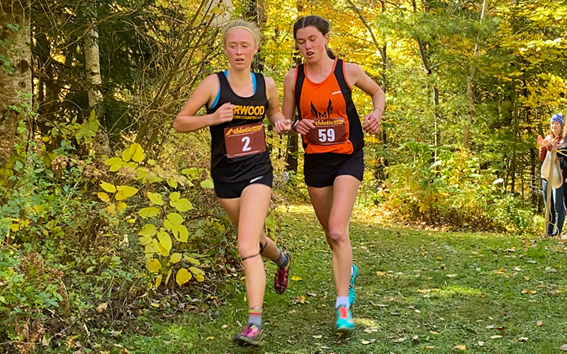 Race winner Julia Thurston, Harwood, leads Middlebury runner. Photo: Robert Commiskey