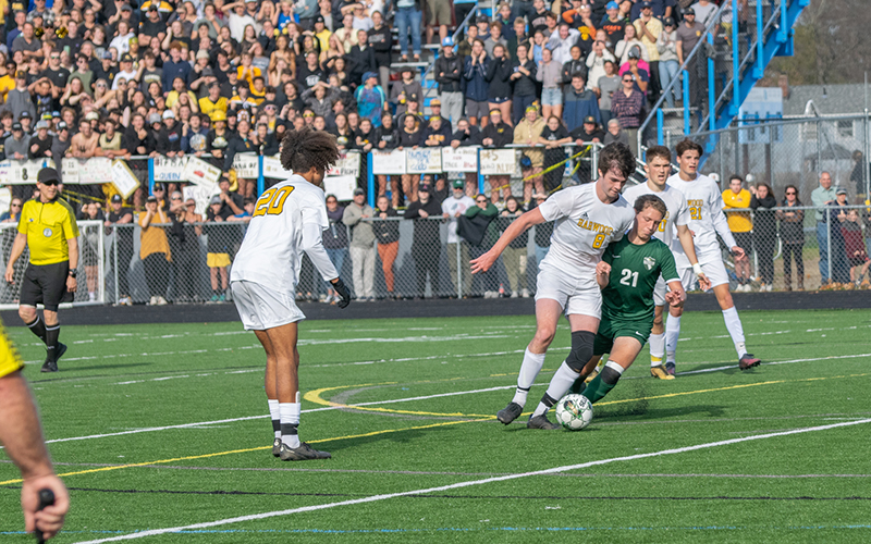 Harwood's Cole Hill drives into Montpelier's penalty box against ten defenders.  Photo: Jeff Knight