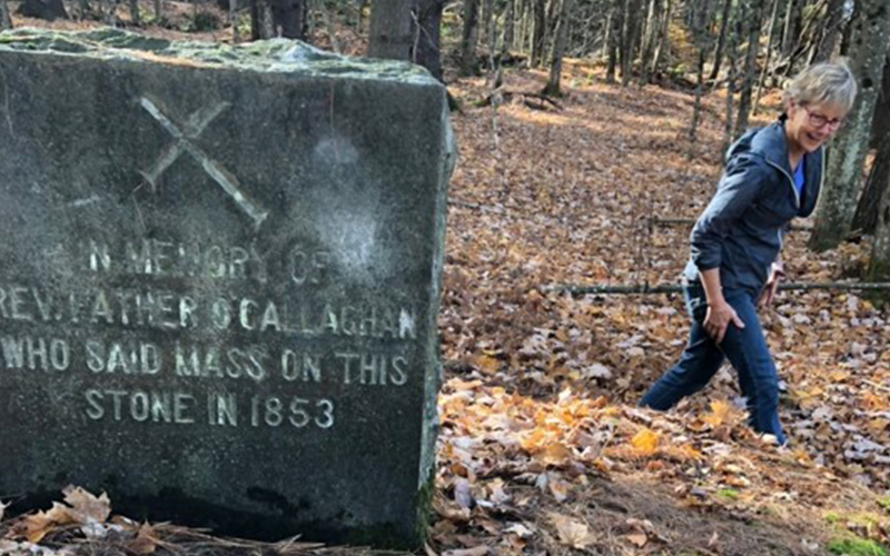 This marker commemorates the first Catholic Mass said in the Mad River Valley. We found the site in the woods on Paddy Hill. Kathleen Cosentino immediately made herself useful by cleaning leaves off the sacred “Altar Rock” while I just stood there gawking. Photo: Mary Kathleen Mehuron.