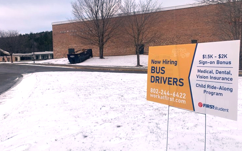 Signs outside Harwood Unified Union School District schools advertise job openings for bus drivers. Photo by Lisa Scagliotti