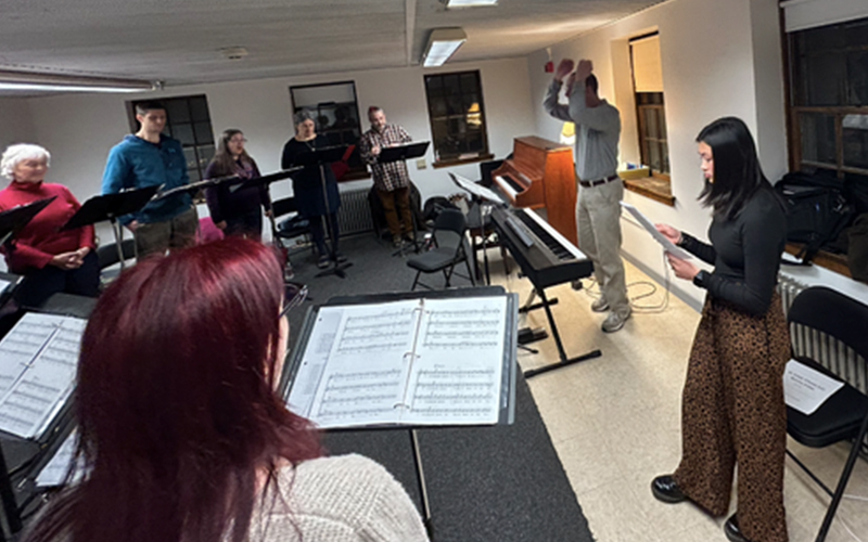 Harwood Union senior Molly Caffry (right) at a rehearsal with the Counterpoint singers and director Nathaniel Lew (second from right). Photo courtesy Music-COMP