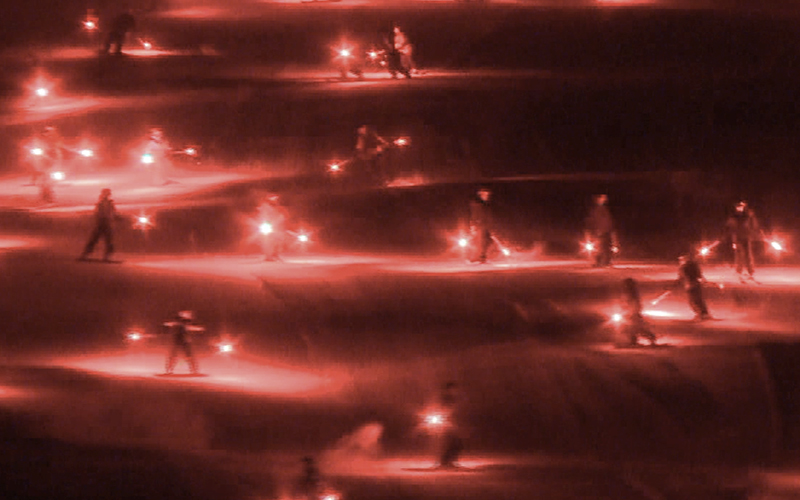 A torchlight parade at Sugarbush Resort creates a glowing red light show.