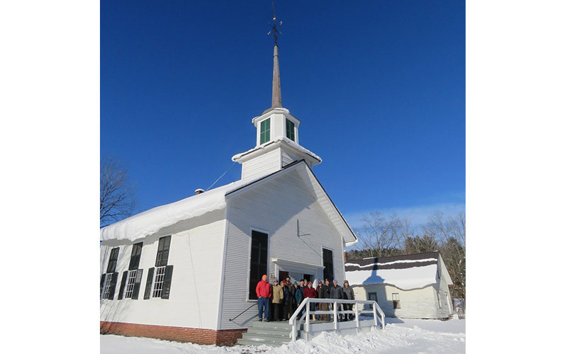 The Duxbury Historical Society pose in front of the former South Duxbury Church that town residents hope to convert into a museum and event venue. Photo: Shawnee Perry.