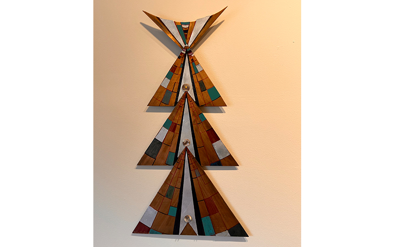 Three pyramids stacked wall hung sculpture. By Mireille Clapp