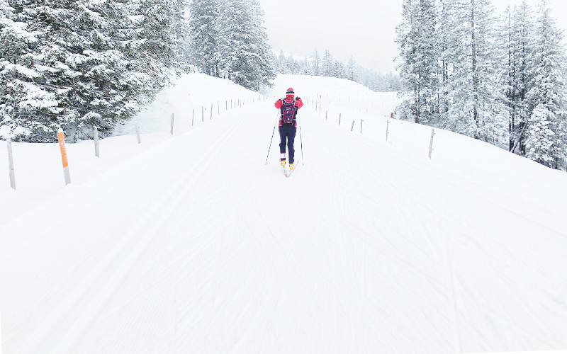 Cross country skier fading into the distance.  Photo art based on photo by Stephane Fellay.