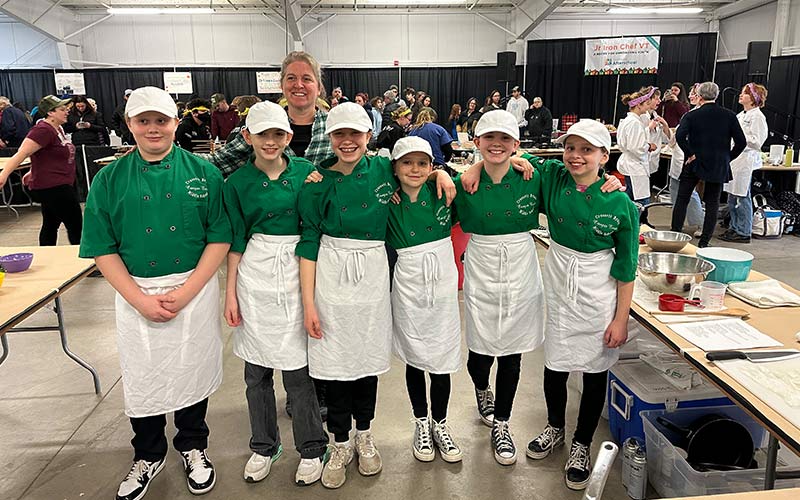 Crossett Brook Middle School Jr. Iron Chef participants: L to R, Thatcher Palmer, Franki Beto, Cora Binkerd, Willa Hudson, Evelyn Andrus, Willow Thomas. Coach Dana Hudson in the back. 