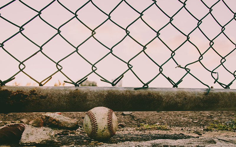 file photo of baseball and fence.