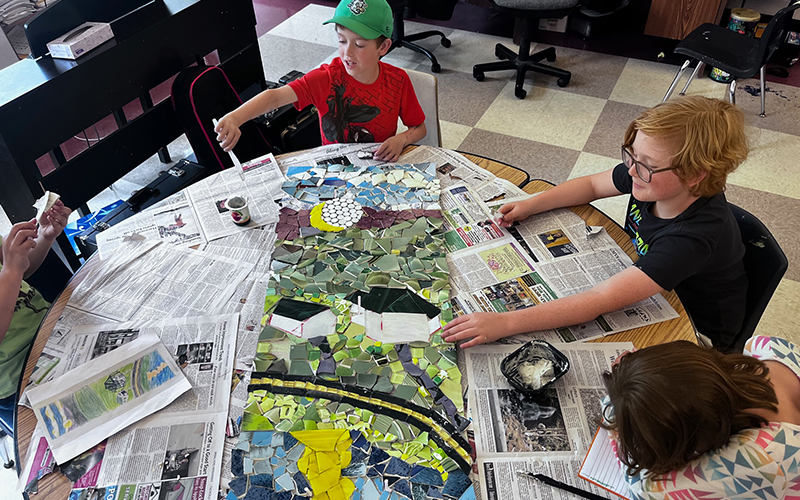 Moretown Elementary School students work on a mosaic they are creating with the help of artist-in-residence Bette Ann Libby. The finished mosaic will be displayed in the school’s library. Photo: Heather O’Hare.