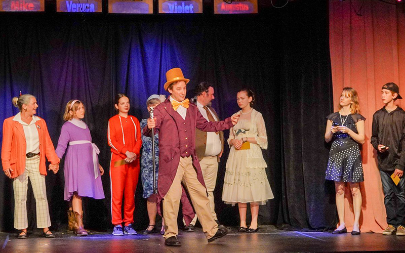 The Golden Ticket winners and their parents meet Willy Wonka (Wes Olds) in the Valley Players' production of “Roald Dahl's Willy Wonka,” running June 29-July 16. From left to right: Charlotte Robinson, Naomi Niweiadomski, Jane Schaefer, Carrie Phillips, Wes Olds, Jordan Streeter, Camille Edgcomb, Stefanie Seng, and Tarin Askew. Photo by Wayne Fawbush.