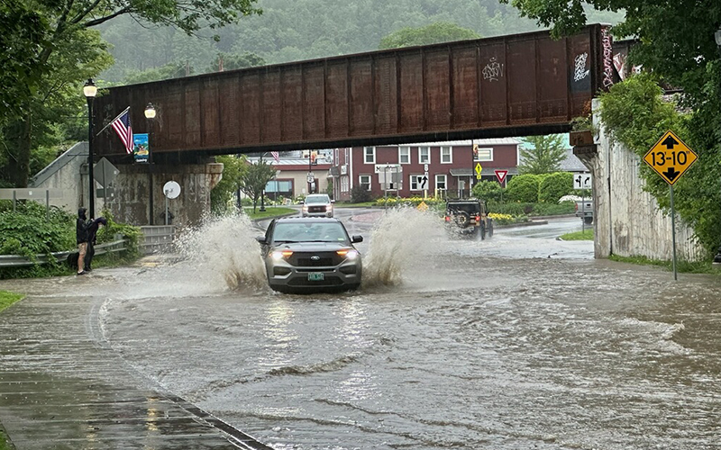 At 6:04 p.m. on July 10, water rises on North Main Street to Dascomb Rowe Park and the roundabout is closed to traffic.