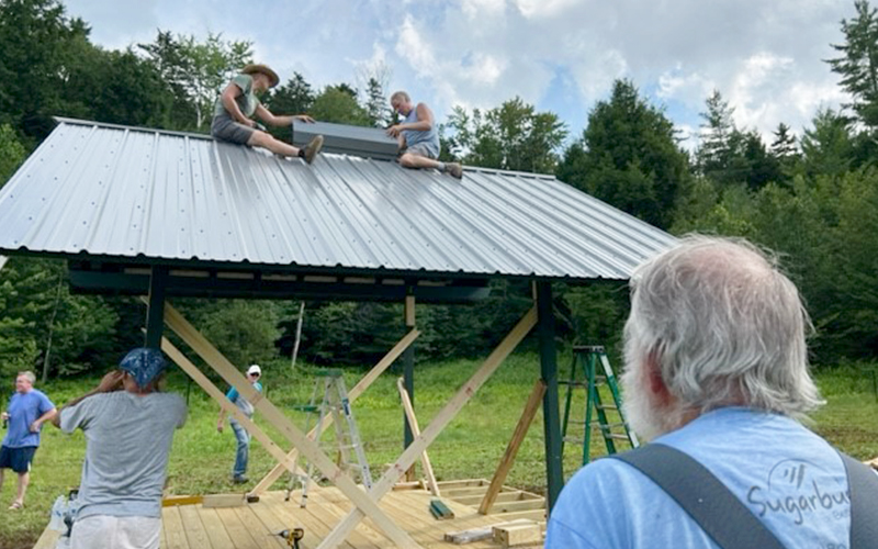 Volunteers constructing welcome center for the Mad River Valley dog park.