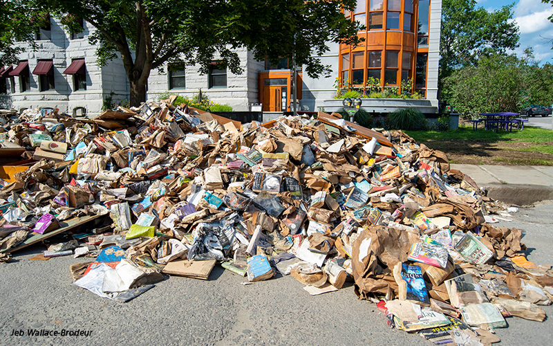 An enormous pile of sodden books from the Kellogg-Hubbard Library's basement used book area sits outside the library on Sunday. Photos by Jeb Wallace-Brodeur