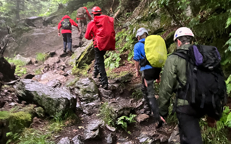 Members of local search and rescue teams head up Camel's Hump searching for an injured hiker. Photo: Brian Lindner.