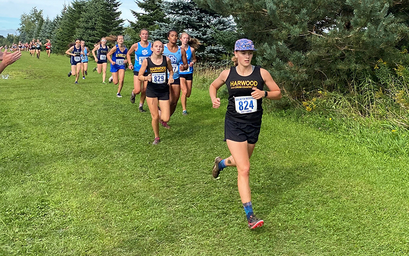 Harwood girls had a fourth-place finish at the Burlington High School Invitational on September 9. Celia Wing (bib 829) finished in 10th place, followed by Heidi Haraldsen (bib 824) in 15th. Photo: Bob Cummiskey.