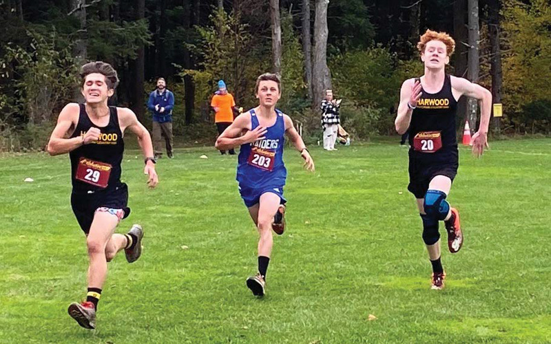 Wyatt Ross (#29) and Atticus Ellis (#20) stride out to beat one of the U-32 runners to the finish line of Saturday’s home meet. Photos: Robert Cummiskey.