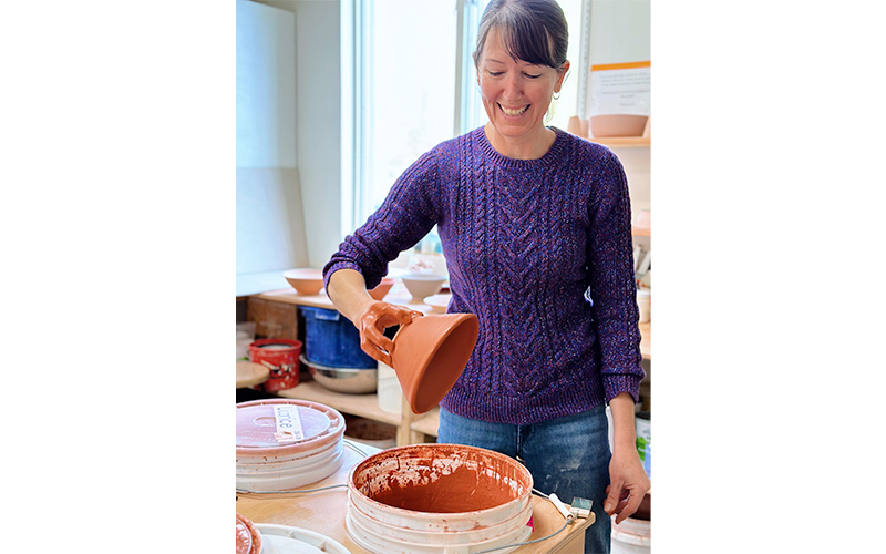 Lindsay Barrett dips a bowl in glaze at Blockhouse Studio in Waitsfield for the Empty Bowl Benefit on November 12.