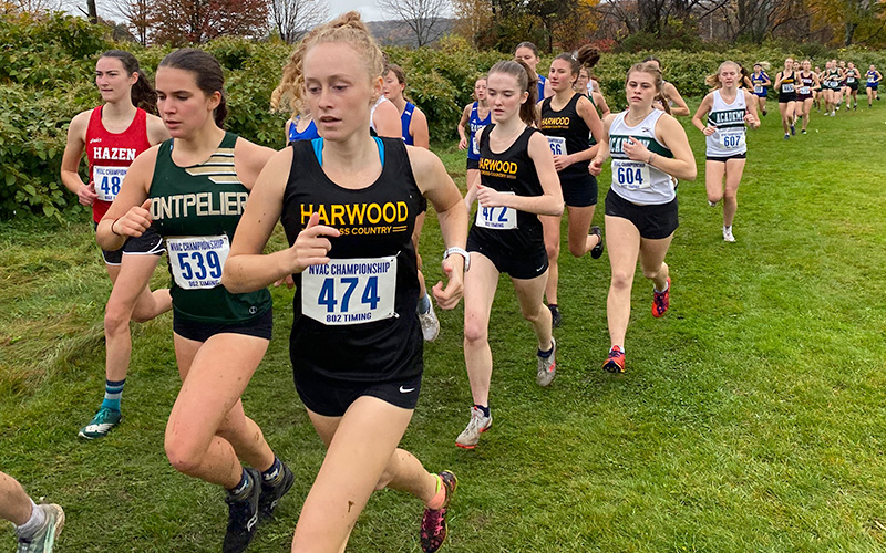 Seniors Julia Thurston, Hazel Lillis, and Rowan Clough (L to R, respectively, in black Harwood shirts) all put forth great effort in one of the last races of their high school careers. Photo: Robert Cummiskey