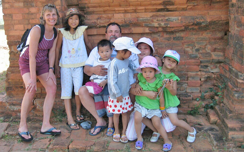 Laura, left, and Dick Kingsbury with Vietnamese children on one of their trips to Vietnam.