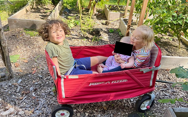 Left-to-Right: Emerson, Baby L, and Olivia enjoy sibling time in the garden.
