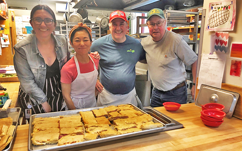 HUUSD nutritionist Erika Dolan, Warren kitchen staff Yukio Cormier and Troy Kingsbury, joined by Gene Hurdle to celebrate the Hurdle Special at Warren School.