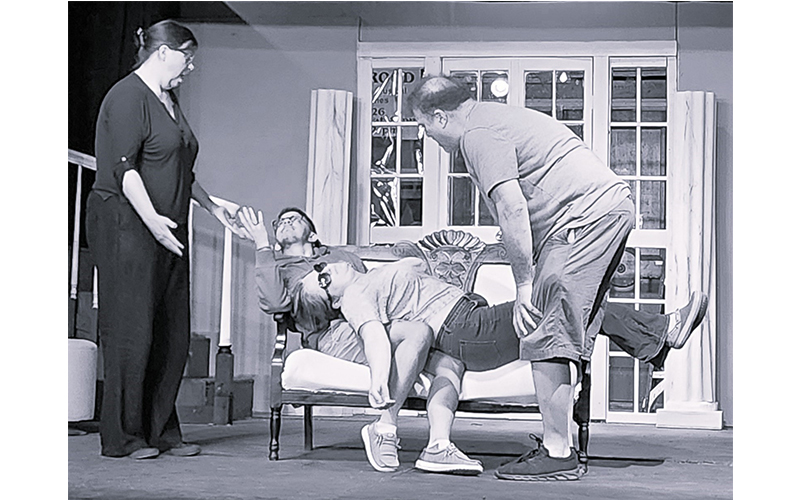 Madame Arcati (Sarah Storjohann) falls into a trance on top of Dr. Bradman (Ray Merrill) while Mrs. Bradman (Sarah McDougal) and Charles (Lee Chasen) try to help in the Valley Players production of “Blithe Spirit,” playing October 10-26 in Waitsfield.