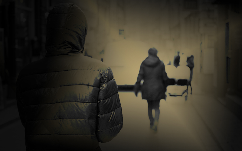 dark image of woman being followed.